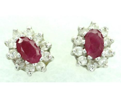 Pair of 18ct gold ruby and diamond set cluster studs, combined 2.1g. All stones present, back present would benefit from a cl