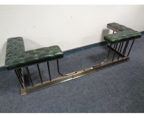 A Victorian style extending brass club fender upholstered in a green button leather 