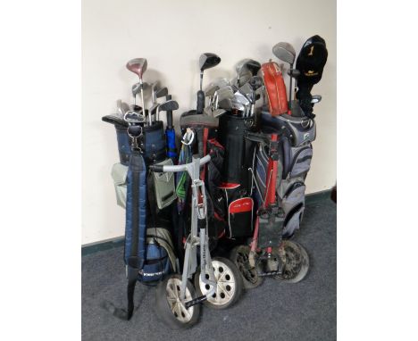 Four golf bags containing assorted irons and drivers to include Dunlop, Howson, Donnay etc, together with two folding golf tr