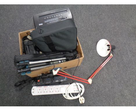 A box containing extension leads, camera tripods, angle poise lamp, laptop bag, paper shredder etc 