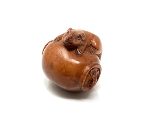 A carved hardwood netsuke - Two rats on a pot
