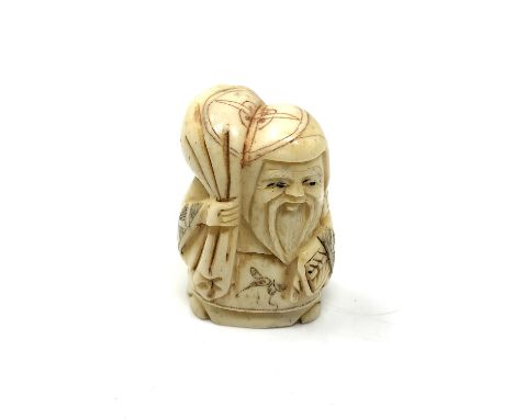 A carved bone netsuke - Elderly man carrying money bag