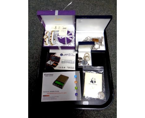 A tray of costume jewellery, lady's bracelet and watch set, WWF coin, digital scales 