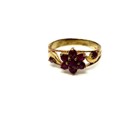 A ruby cluster ring on yellow metal shank, size T  
