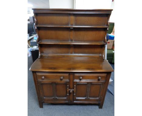 An Ercol solid elm and beech Welsh dresser in an antique finish 