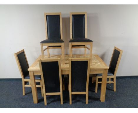 A light oak kitchen table together with a set of six high back chairs  