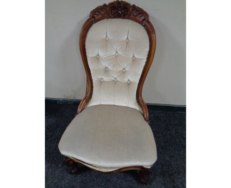 A 19th century mahogany nursing chair upholstered in a button dralon fabric 