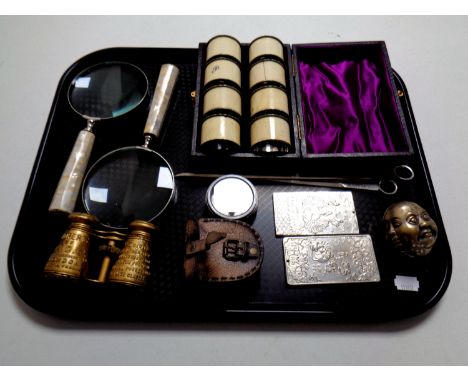 A tray of miscellany to include a reproduction marine compass in leather punch plated meat skewers, Chinese ingots, cased sil