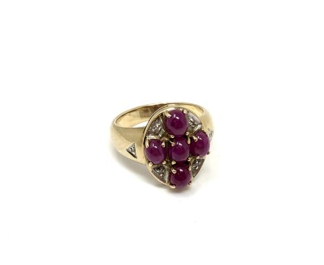 A 9ct gold cabochon ruby cluster ring, size N.