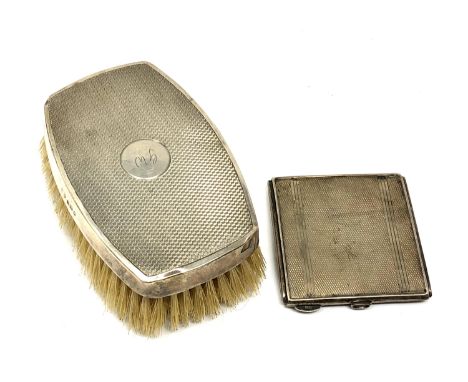 A silver compact with engine turned decoration, together with a silver dressing table brush 