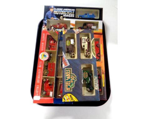 A tray containing five die cast car sets to include London's Fire Engine, Classic American Motorcycle Marques, Hotel labels o