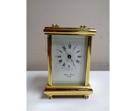 A brass cased Philip Morris eleven jewel carriage clock with key 
