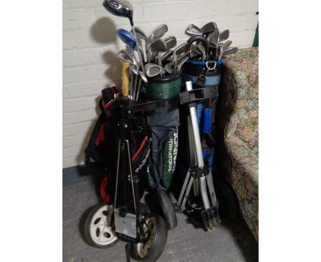 Three golf bags of assorted irons and drivers to include Dunlop, Ben Sayers, Big Bursar, together with two folding golf troll