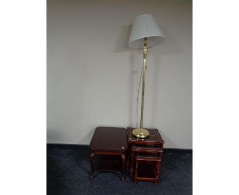 A two tier occasional table together with a nest of three glass topped tables in a mahogany finish, together with a brass flo