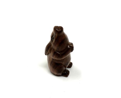 A carved hardwood netsuke - Seated rabbit 