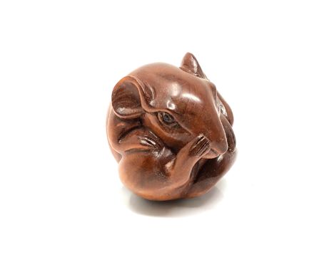 A carved hardwood netsuke - Rat scratching its nose 