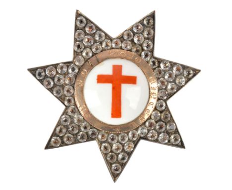 A past set masonic badge, the silver five pointed star encrusted with simulated diamonds, a red cross against a white ground 