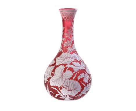 A Stourbridge pale-red and opaque-white cameo glass bottle vase, circa 1885, carved in relief with ferns and grasses beneath 