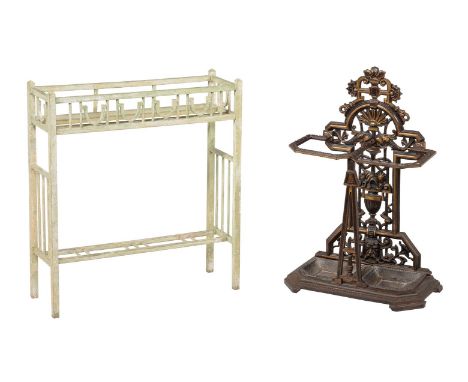 A cast iron stick stand, second half 19th century, with nautical motifs and twin removable drip pans, the underside with indi