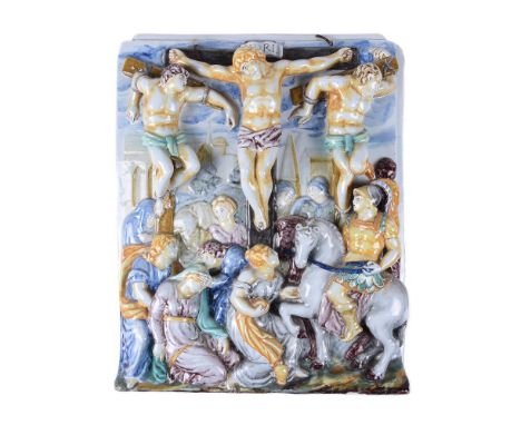 An Italian maiolica wall tile moulded in relief with The Crucifixion, circa 1900, painted in colours, spurious date verso M 1