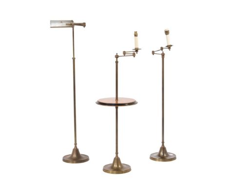 An oak and brass reading standard lamp, with spread base, 118cm high at its lowest, together with another similar without the