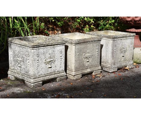 A set of three composition stone planters, 20th century, after the manner of Robert Adam, each with a central urn to the fron