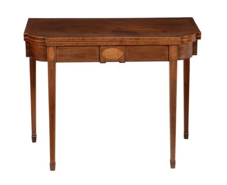 A George III mahogany and inlaid tea table, circa 1790, the top with shaped corners above the frieze with central tablet and 