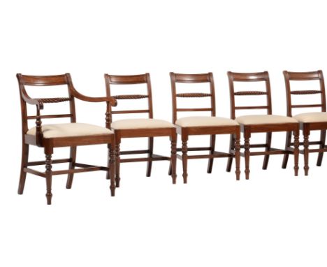 A set of eight Regency mahogany dining chairs, circa 1820, to include a pair of armchairs, each with a cream upholstered drop