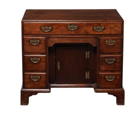 A George II 'red walnut' kneehole desk, circa 1740, with caddy top above the arrangement of drawers, 82cm high, 90cm wide, 50