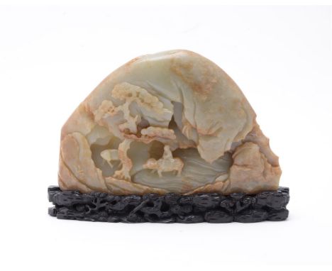 A Chinese mottled celadon jade boulder, the front well carved with one scholar crossing a bridge, the other scholar sitting i