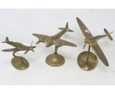 Three brass fighter aeroplanes on brass stands, largest bears label for Bates Brass Birmingham, largest H: 15 cm. UK P&amp;P 