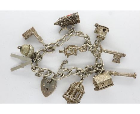 Hallmarked silver charm bracelet with ten charms, padlock clasp and safety chain, L: 18 cm. UK P&amp;P Group 0 (£6+VAT for th