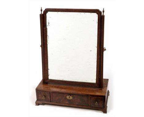 A Georgian mahogany swing framed toilet mirror , the arched plate with fluted border between uprights, the box base with thre