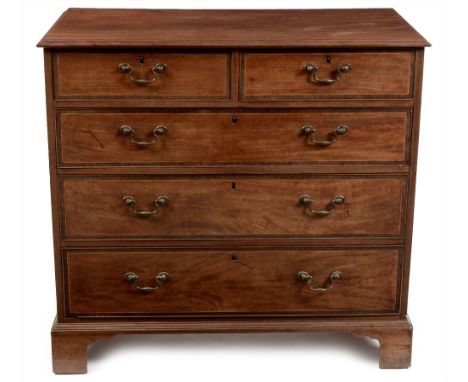 A George III mahogany and crossbanded chest of drawers, the rectangular moulded top above an arrangement of two short over th