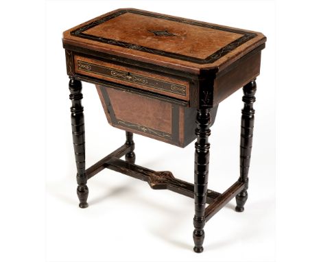 A late Victorian amboyna and ebonised work table, the rectangular hinged top with canted corners enclosing a games surface fo