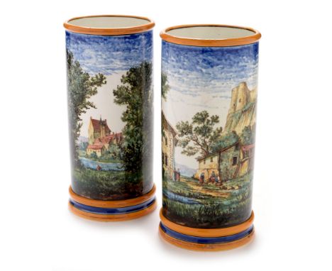 A pair of Gien Faience pottery vases, each painted with a continuous scene with castles, ruins, windmill and figures in a lan
