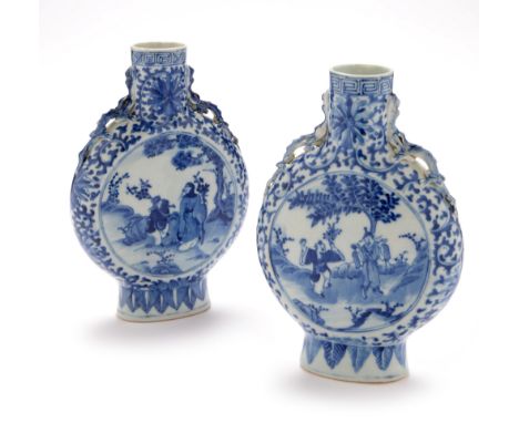 A pair of Chinese blue and white porcelain moon flasks , late 19th Century, each decorated with figural panels on foliate scr