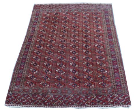 Tekke Torkman carpet, with six rows of fourteen tekke gul medallions, 223 x 302cms.