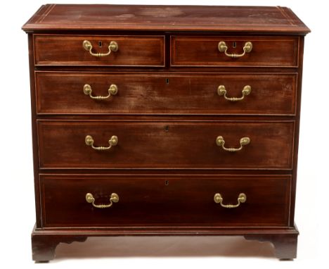 A George III mahogany and boxwood strung chest of drawers, the moulded rectangular top above an arrangement of two short over