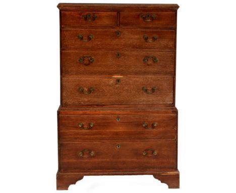 A George III oak chest on chest , the rectangular moulded top above an arrangement of two short over five long graduated draw