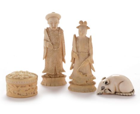A pair of late 19th Century Chinese carved ivory chess pieces as an emperor and empress in traditional costume, 8 and 9cms; a