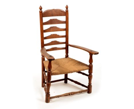 A 19th Century elm ladder back armchair , the arched top rail with turned finials above a rush-work seat, raised on turned le