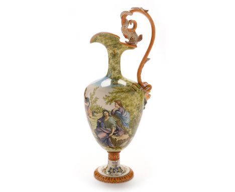 A Ginori maiolica wine ewer , early 20th century, decorated with a continuous classical scene in a landscape, dolphin scroll 