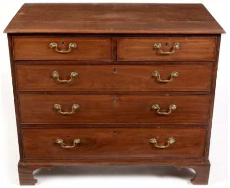 A George III mahogany and boxwood strung chest of drawers, the rectangular moulded top above and arrangement of two short ove