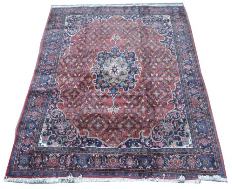 Bidjar carpet, the central rosette surrounded by floral scrolls on red ground, 213 x 282cms.