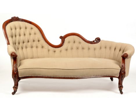 A Victorian mahogany framed camel-back sofa, with undulating and scrolled top-rail enclosing a deep-button back and sides abo