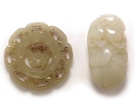 A Chinese pale green Jade pebble carved in the form of a fungus, 6cms; and a pale green jade pierced disk carved with a butte