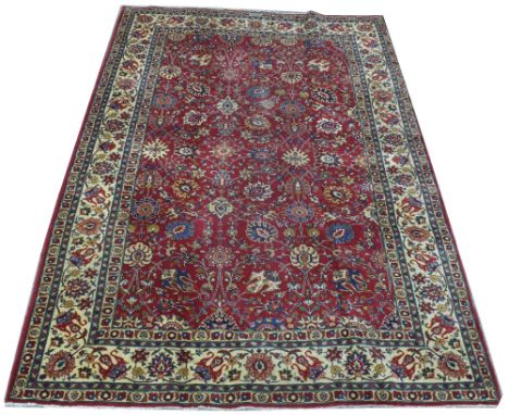 Tabriz carpet, with floral scrolling design on red ground, 227 x 343cms.