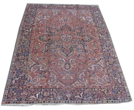 Heriz carpet, the central star-shaped medallion and surround decorated with geometric floral design, 265 x 356cms.