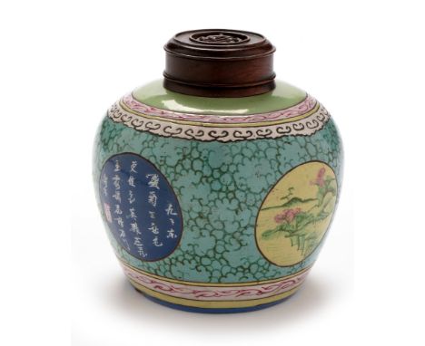 A Chinese terracotta ginger jar, decorated with landscape and script panels on a blue and green ground, turned hardwood cover